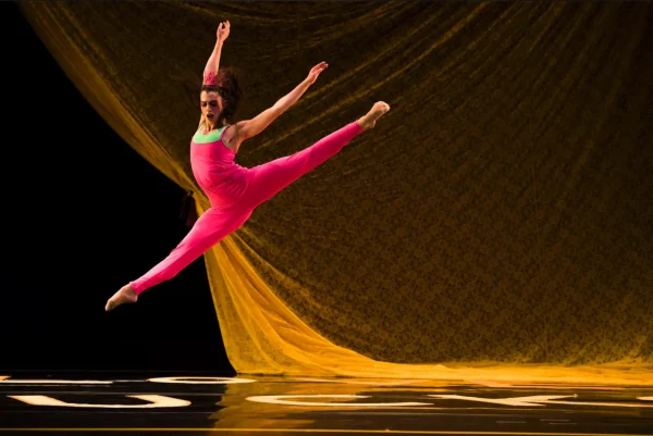 A dancer in red jumps
