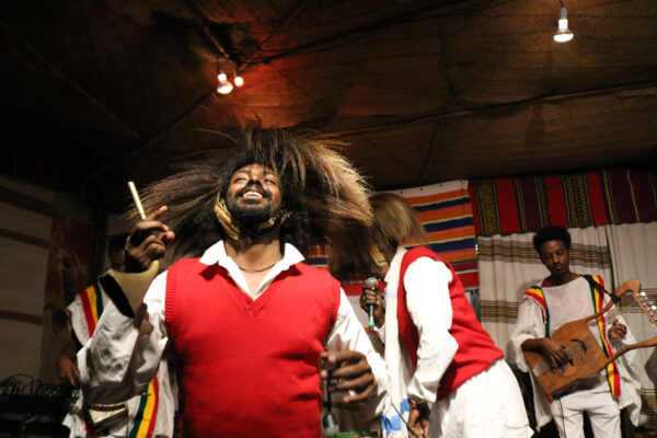 Dancers in red vests and white shirts