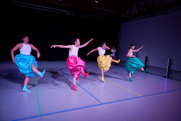 Dancers in multi-colored skirts