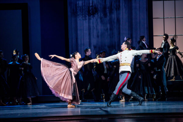 A man holds a woman in arabesque