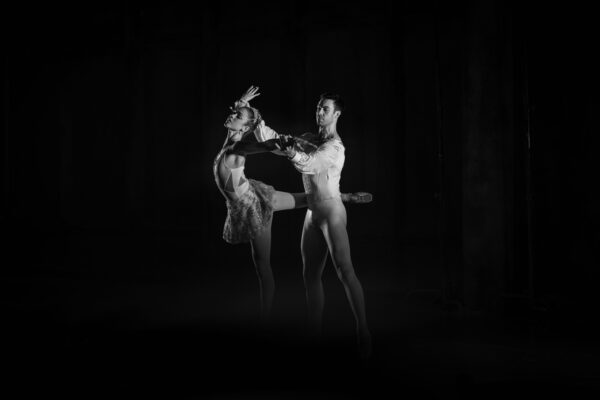 A couple dance in the shadows
