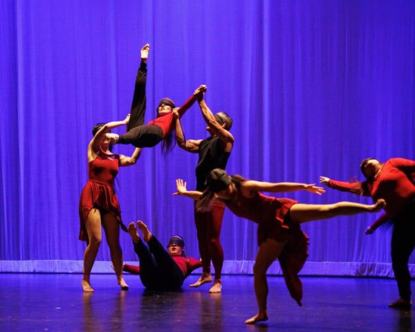 A dance group in black and red