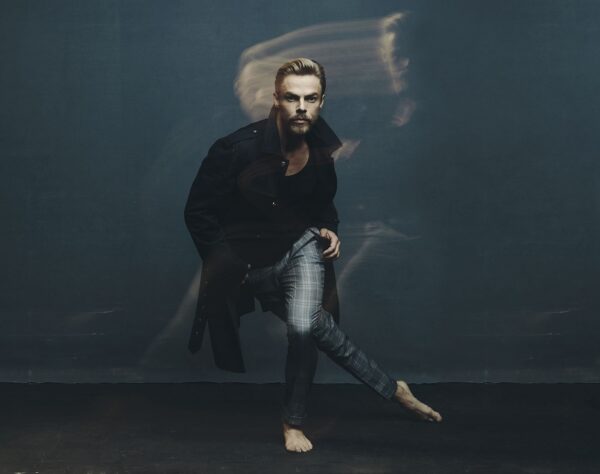 A barefoot man dances