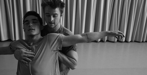 A man holds another dancer