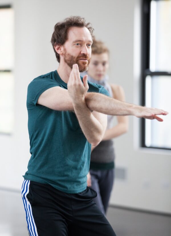 A dancer crosses his arms