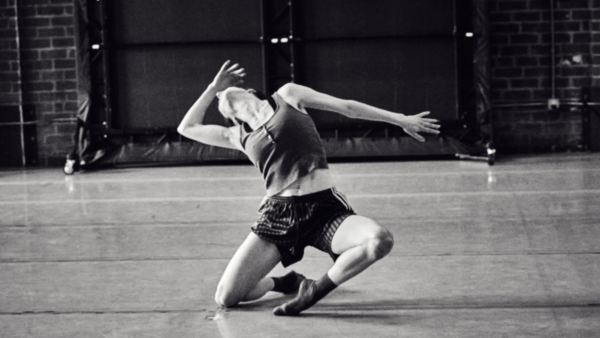A dancer on floor bends back