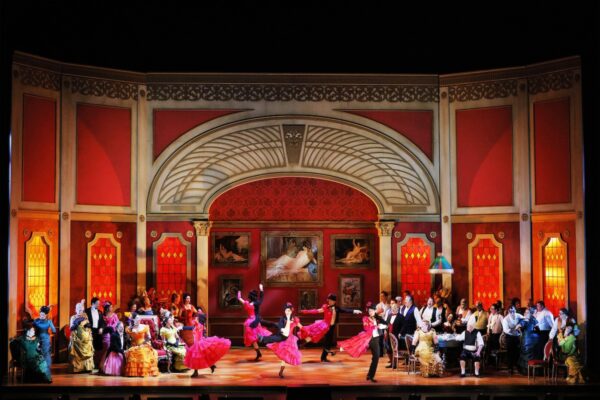 Dancers in center of a stage in LA Opera's La Traviata. Photo by Cory Weaver
