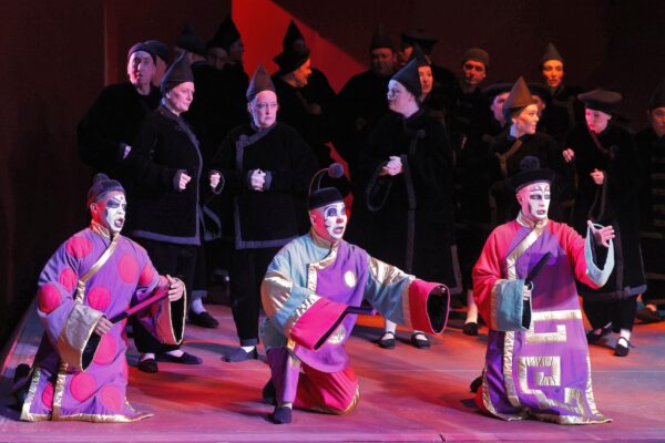 Three performers in Chinese garb from LA Opera's Turandot, featuring a set designed David Hockney