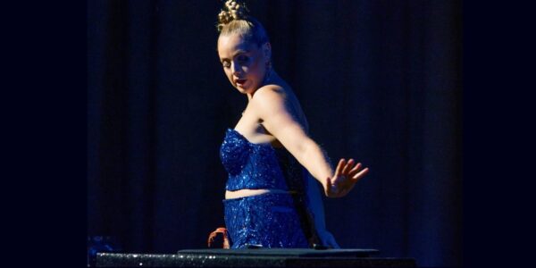 A blond woman in blue sparkle dress