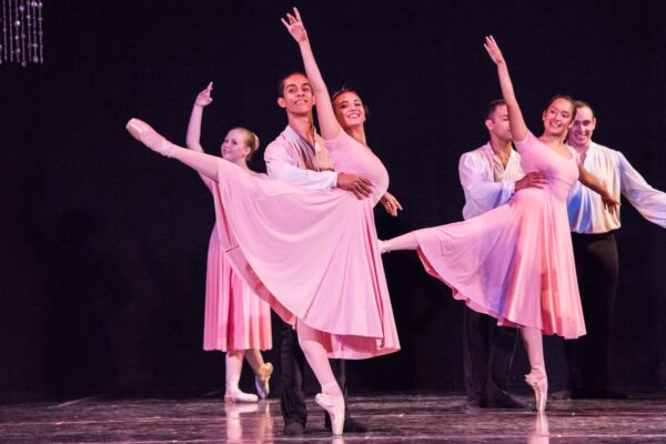 Dancers in pink in arabesque