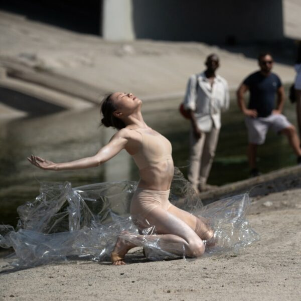 A dancer bends back