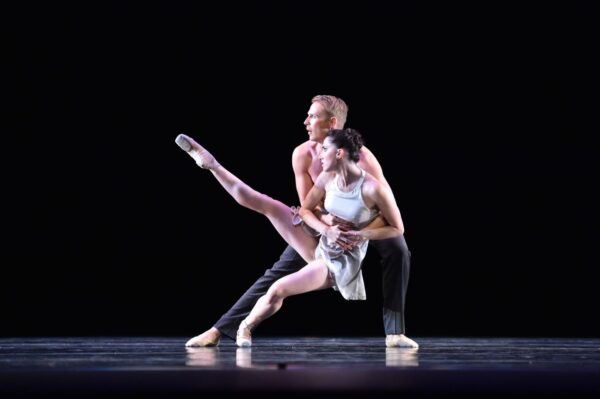 A dancer in white is held by her partner