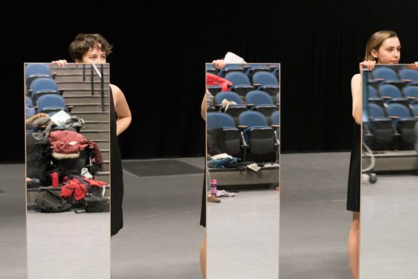 Dancers holding mirrors in Mirror Piece