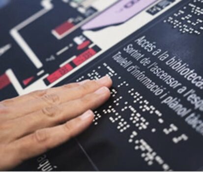 Person touching braille sign