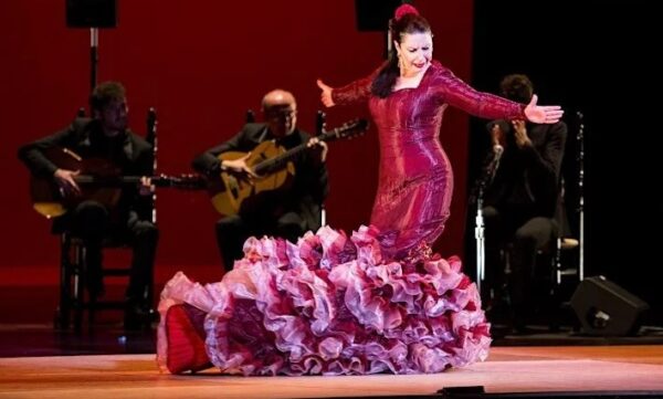 A flamenco dancer with musicians