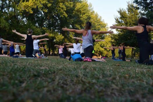 women doing yoga in field