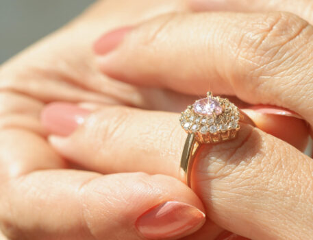 Close up view of a diamond ring and woman hand