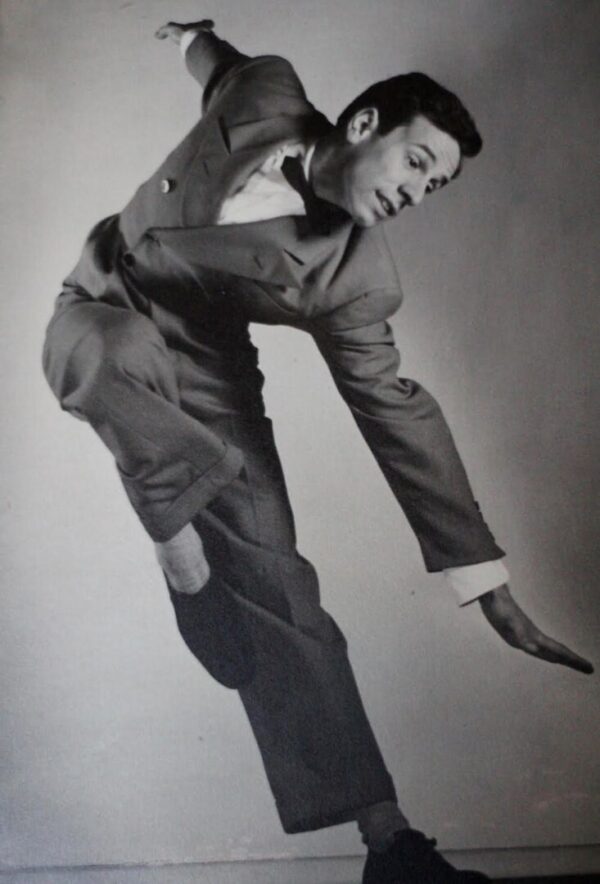 A dancer jumps to the side