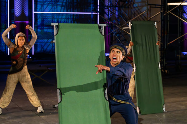 A man hold a green stretcher
