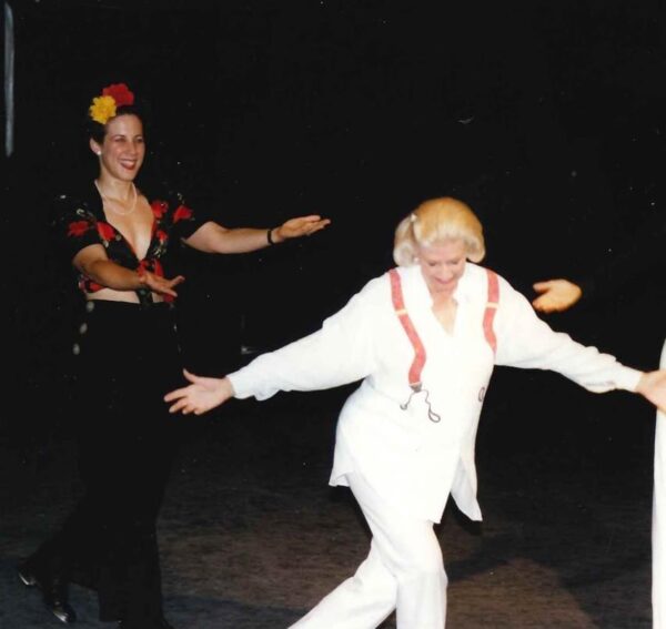A dancer in white bows