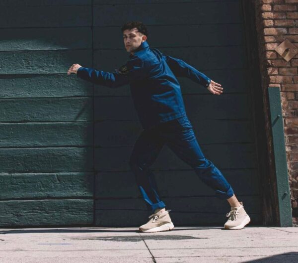 A dancer in blue lunges