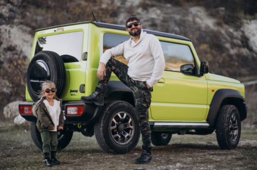 Father and daugher standing in front of Suzuki Jimny.