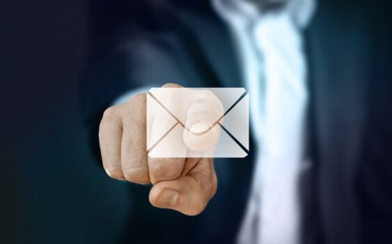 Business man pointing to mail icon.