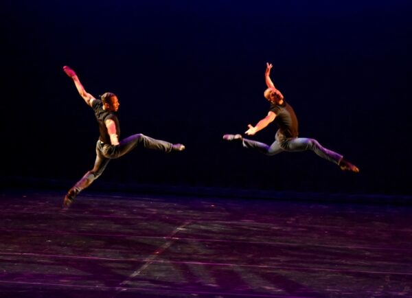 Two dancers in blue jump