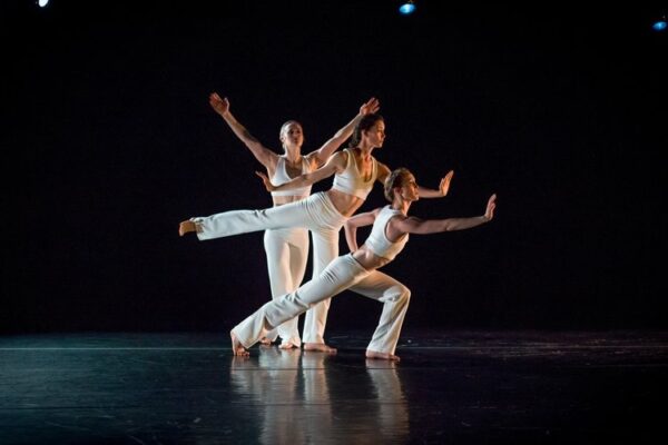 Three dancers in different poses