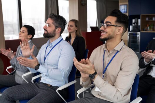 Employees in chair clapping.