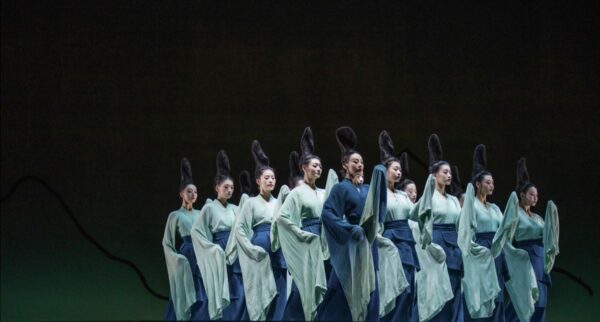 A line of dancers with large hair