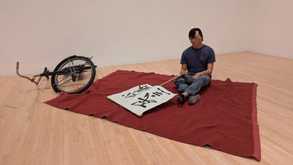 Duane Hanson (1925-1996), Chinese Student, 1989, autobody filler, polychromed in oil, mixed media, with accessories; courtesy the Estate of Duane Hanson and Gagosian, © 2024 Estate of Duane Hanson/Licensed by VAGA at Artists Rights Society (ARS), New York, installation photograph by Stephen West.