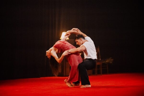 A man holds a dancer bending backwards