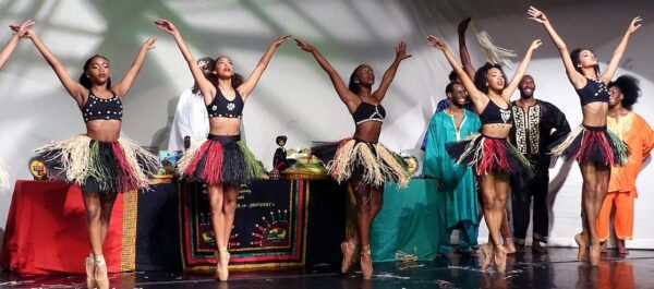 dancers in pointe shoes in front of musicians