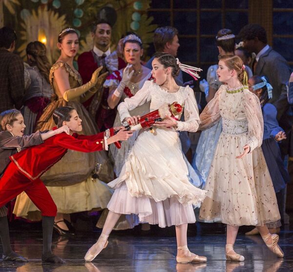 A girl and a boy tug at a Nutcracker