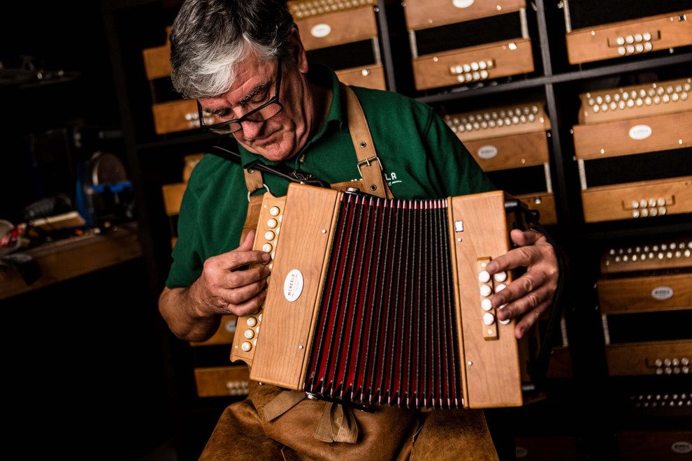 man playing button accordion