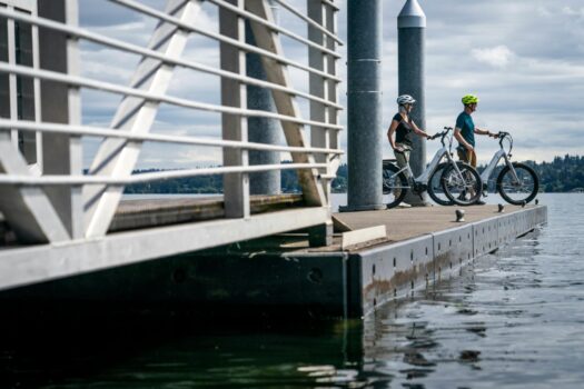 Two people on a port with their electrical bike.