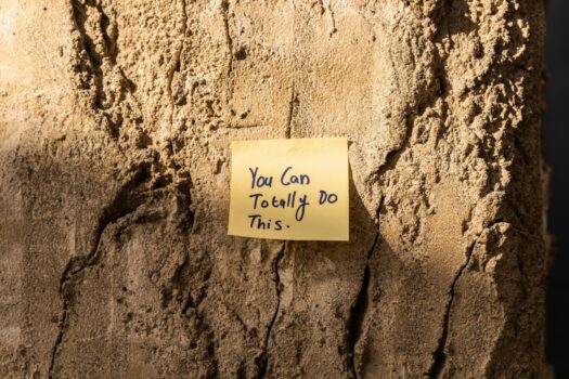 Post-it on wall that says 