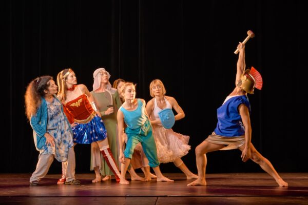 A dancer in blue confronts a group