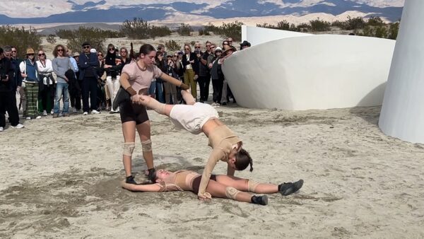 Three dancers by the sculpture