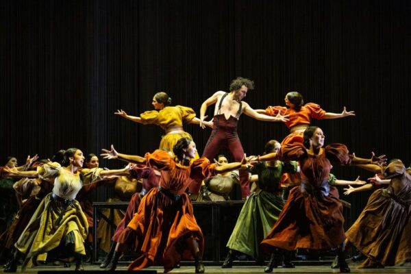 A male dancer surrounded by other dancers