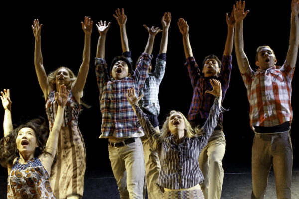 Dancers lift arms