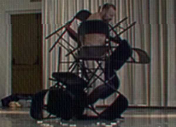 A dancer imbedded among chairs