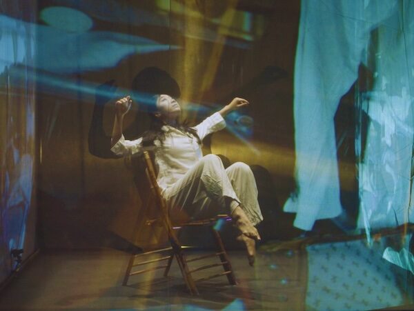 A dancer sits in a chair
