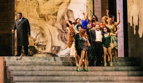 A man surrounded by dancers in Rigoletto