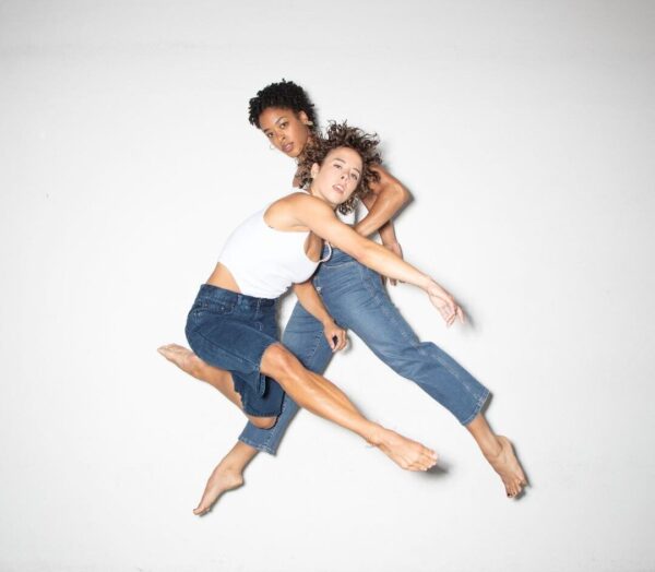 Two dancers against a white background