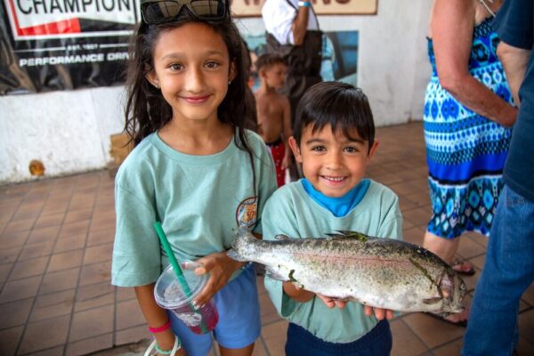 Two children holding fish