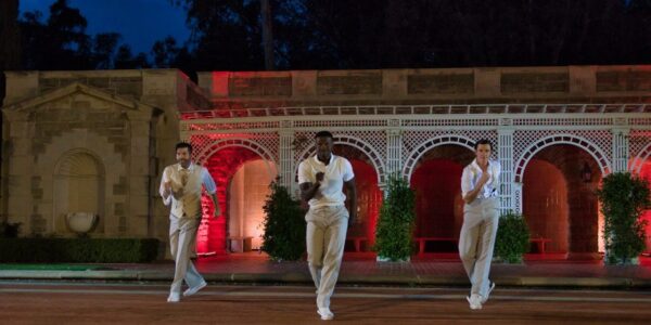 Three men in white dance in Gatsby Redux