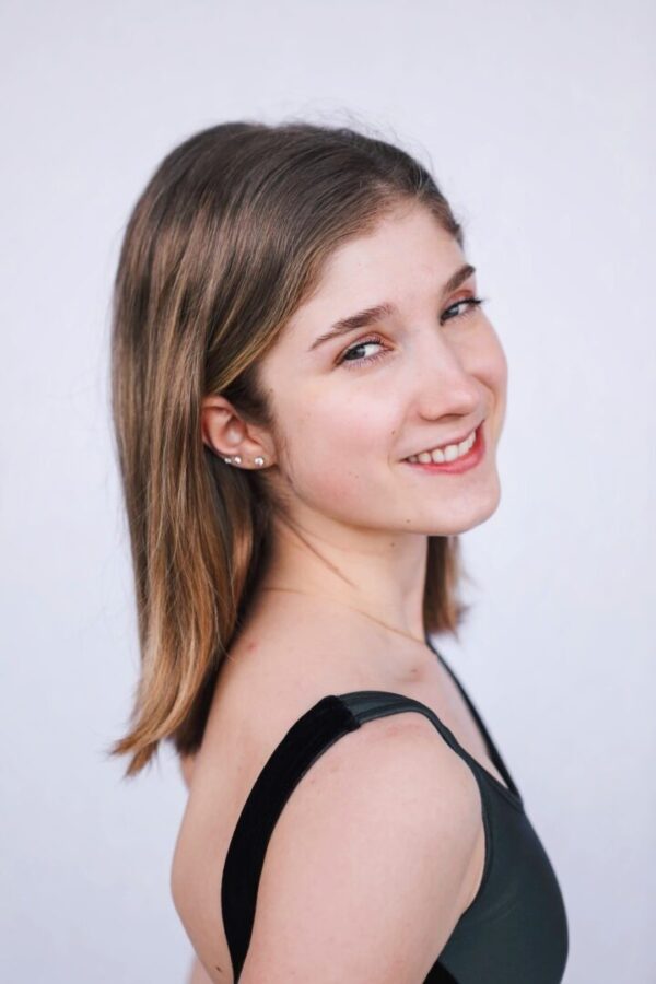 A woman smiles at the camera