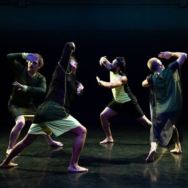 A group of dancers in shadow